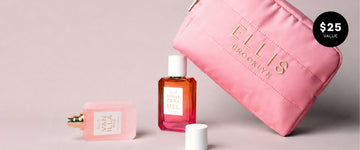 Pink Cosmetic Bag with gold embroidery that reads "Ellis Brooklyn" propped up on QUEENS CARAMEL Eau de Parfum 50ml and behind VANILLA RICE Eau de Parfum 50ml without cap laying down next to cap on gray background with black circle and white text that reads "$25 Value"