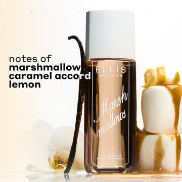 MARSHMALLOWS Perfume Mist 240ml between 2 stacked marshmallows covered in dripping caramel and topped with a lemon peel and a vanilla bean and flower leaning against the bottle on a white background with black text that reads 