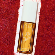 90mL Miss Amber Perfume Mist bottle framed by a red textured backdrop.