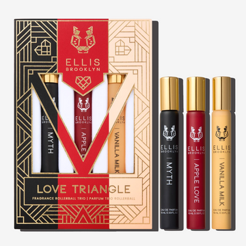 Black, red, beige and gold Love Triangle Fragrance Rollerball Trio Box showing Myth 10ml Fragrance Rollerball, Apple Love 10ml Fragrance Rollerball, and Vanilla Milk 10ml Fragrance Rollerball, on white background. | english_image