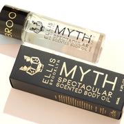 Huile corporelle parfumée Myth Spectacular 95ml à côté de la boîte de l'huile corporelle parfumée Myth Spectacular 95ml, sur fond blanc.
