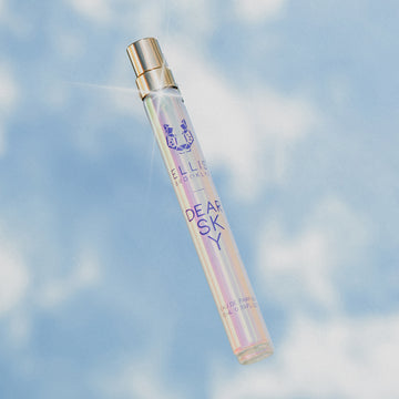 Dear Sky 10ml Eau De Parfum Travel Spray on sky and cloud background.