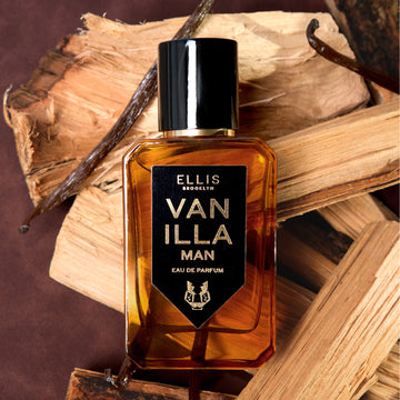 Vanilla Man 50ml Eau De Parfum on pieces of wood and vanilla beans, on brown background. | english_image