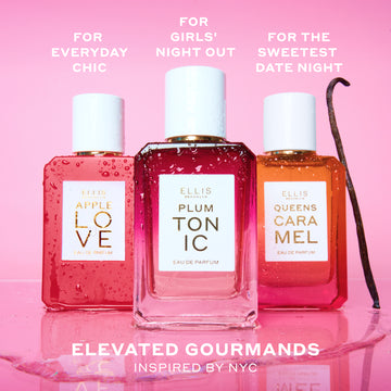 APPLE LOVE Eau de Parfum 50ml, PLUM TONIC Eau de Parfum 50ml, and QUEENS CARAMEL Eau de Parfum 50ml covered in water droplets next to vanilla bean and on top of water puddle on pink background with white text that reads 